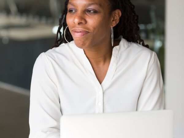 woman wearing white button up shirt sitting in front of table