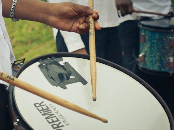 close up of drummer playing snare drum outdoors