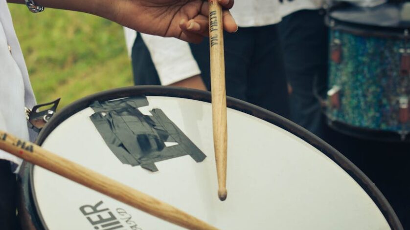 close up of drummer playing snare drum outdoors