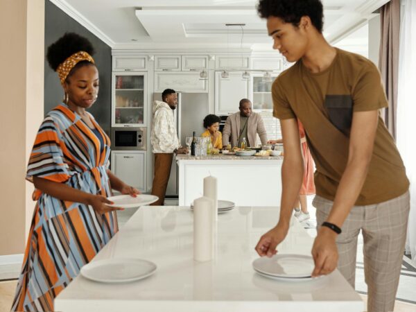 family setting the table for dinner