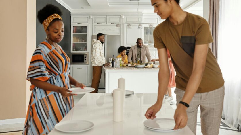 family setting the table for dinner