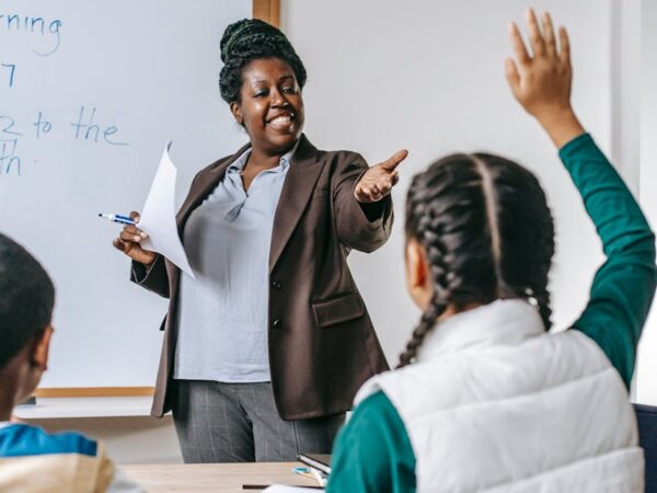 black teacher answering questions of pupil