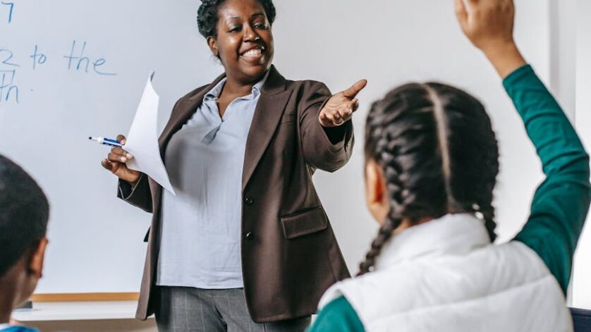 black teacher answering questions of pupil