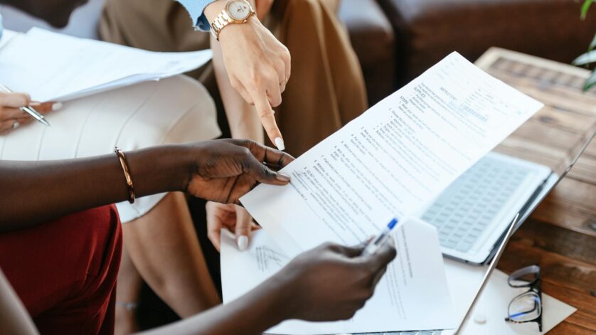 multiethnic businesswomen checking information in documents