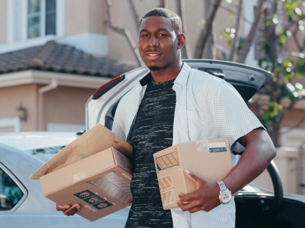 man in white button up shirt delivering packages