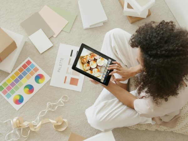 woman in white shirt holding black tablet computer