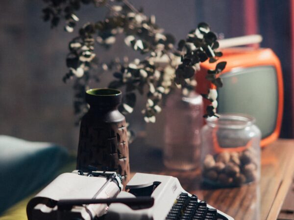 vintage typewriter and television on wooden table