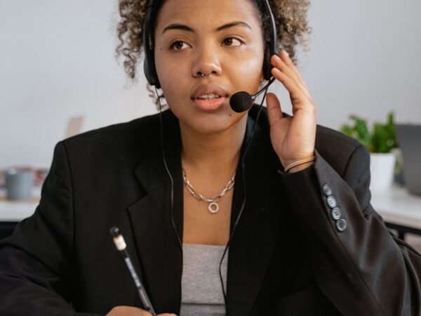 woman in black blazer wearing headset