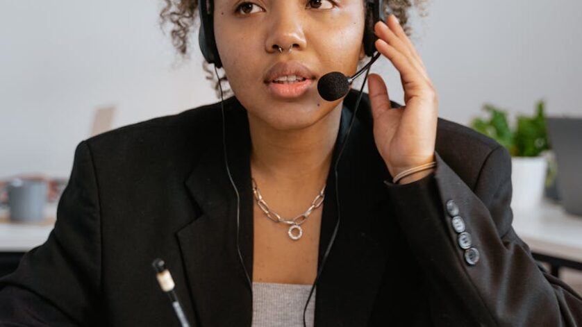 woman in black blazer wearing headset