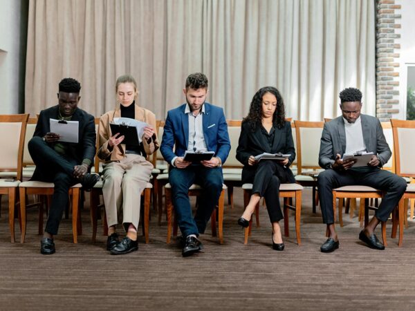 a people sitting on chairs together
