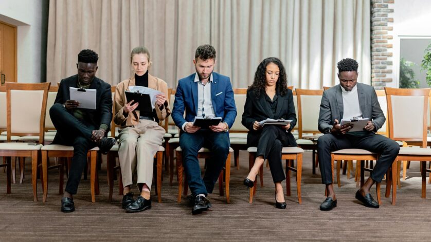 a people sitting on chairs together