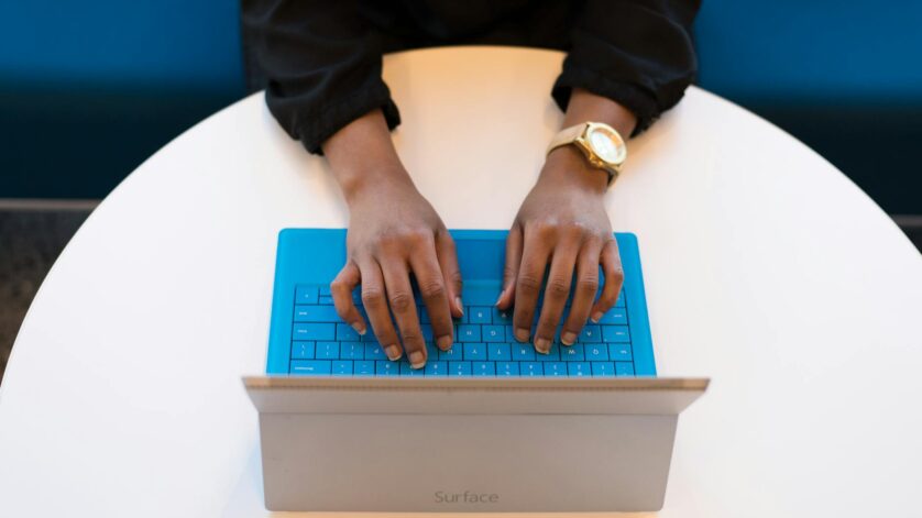 person typing on a laptop