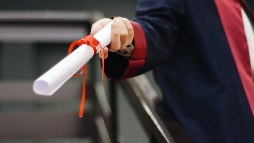 person holding white scroll