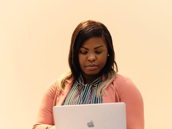 focused businesswoman working on laptop indoors