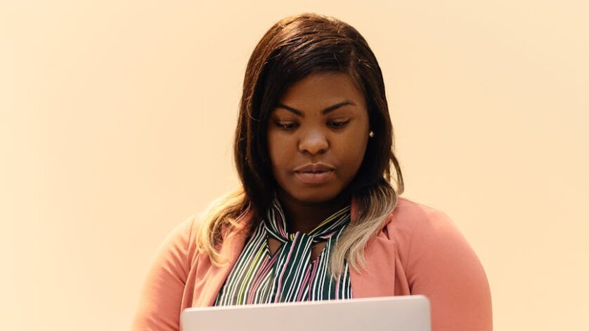 focused businesswoman working on laptop indoors