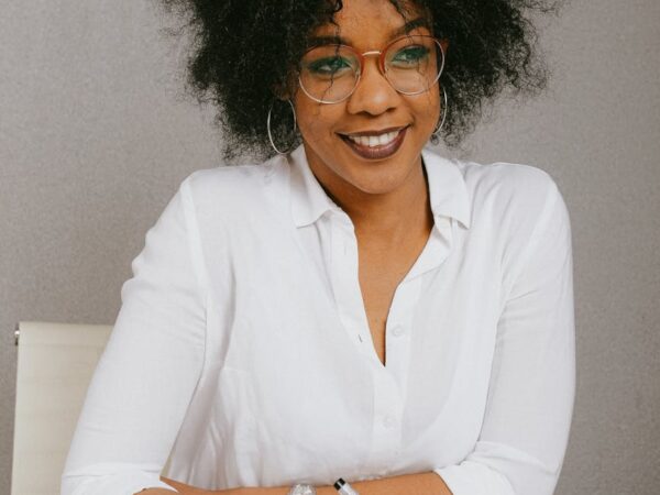 woman in white dress shirt wearing eyeglasses