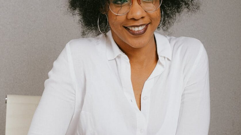 woman in white dress shirt wearing eyeglasses