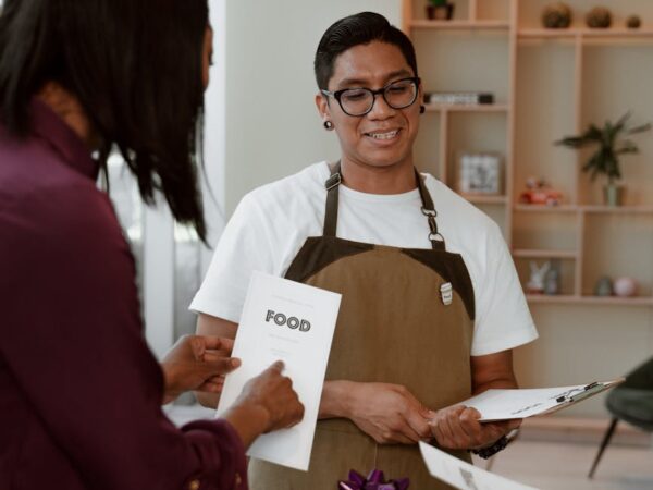 waiter standing in front of a customer
