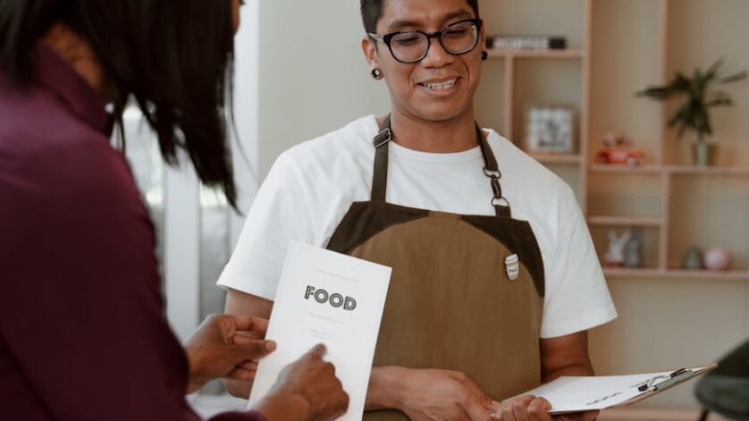 waiter standing in front of a customer