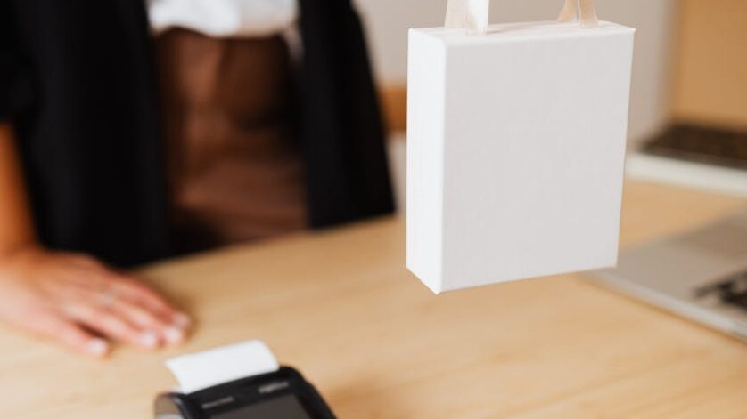 a person holding a white box with handle