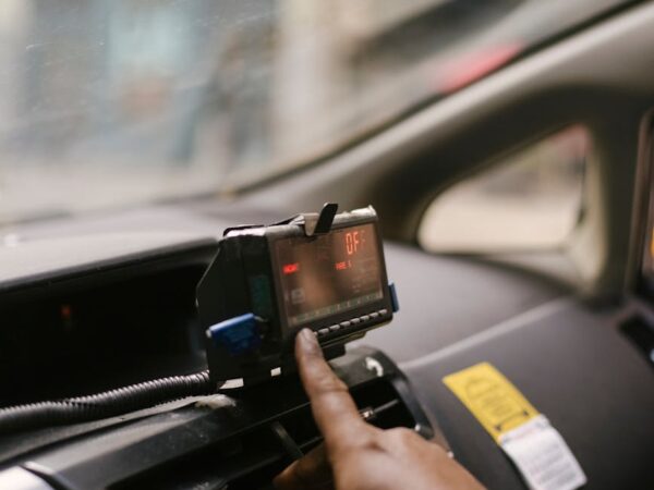 crop ethnic man using gps in cab