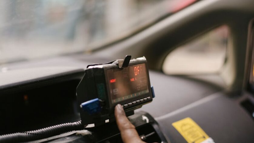 crop ethnic man using gps in cab