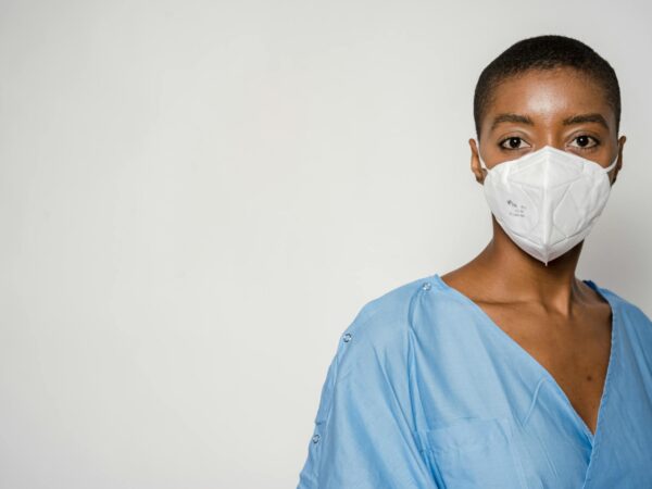 female doctor in medical mask and blue uniform