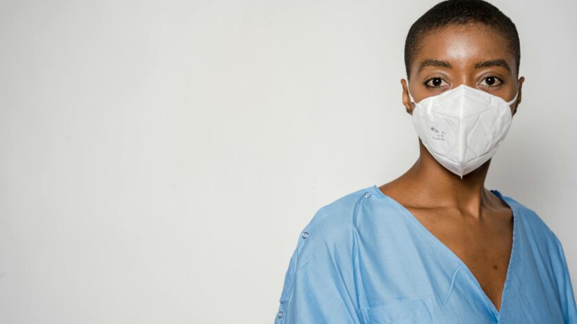 female doctor in medical mask and blue uniform