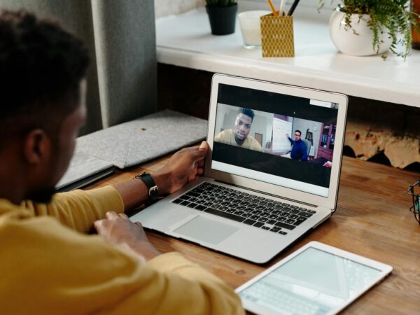 person in yellow long sleeve shirt using a laptop