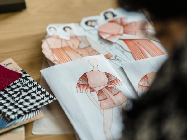 crop designer working at table with clothing illustrations