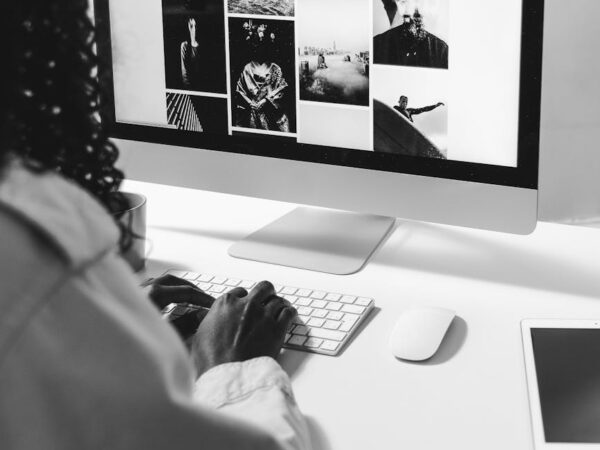 black woman typing on keyboard of modern computer