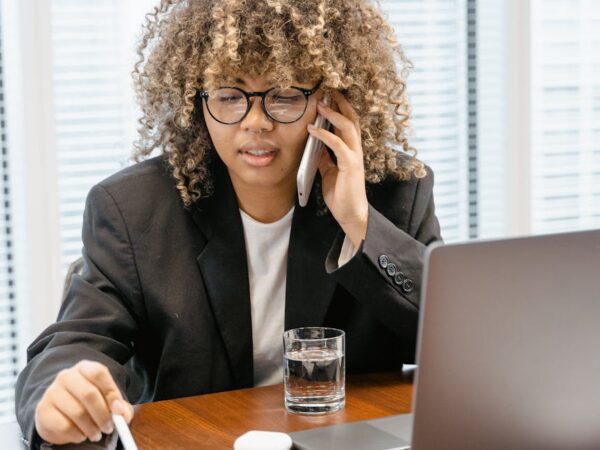 woman in black blazer sitting at the table
