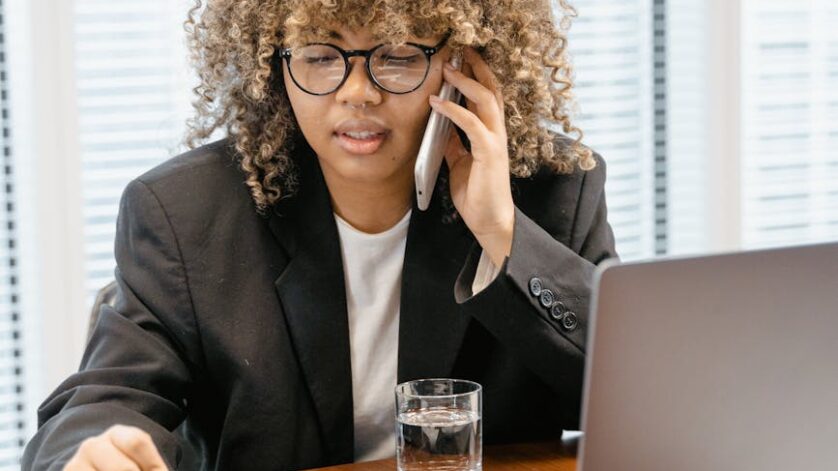 woman in black blazer sitting at the table
