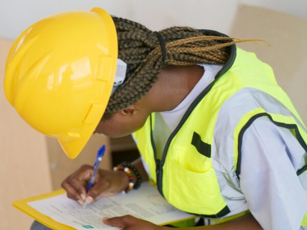 woman engineer writing down on paper