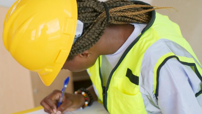 woman engineer writing down on paper