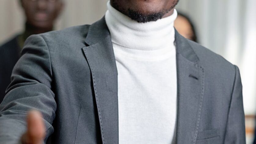 a man in a suit and a turtleneck