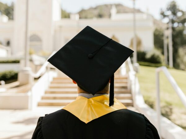 a graduate wearing a mortarboard and a graduation gown