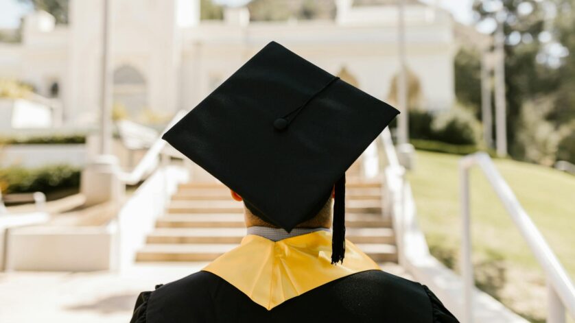 a graduate wearing a mortarboard and a graduation gown