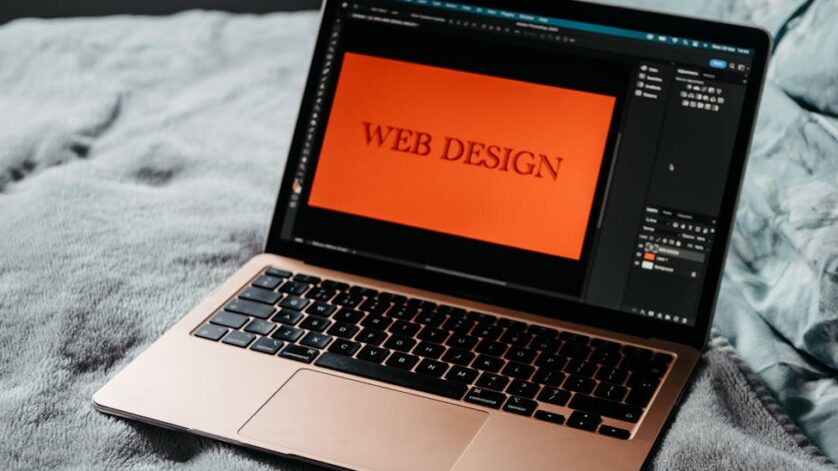 open laptop web design development on bed