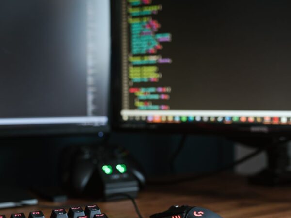 contemporary computer monitors on wooden desk