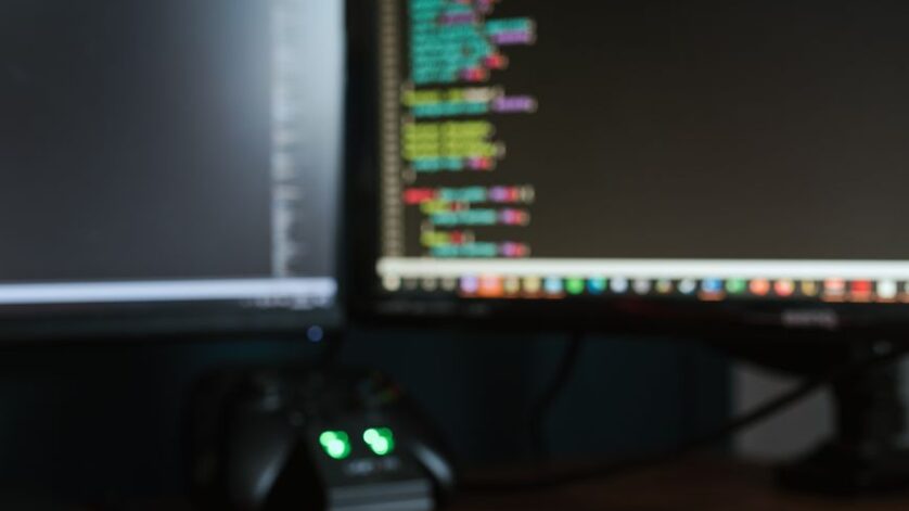 contemporary computer monitors on wooden desk
